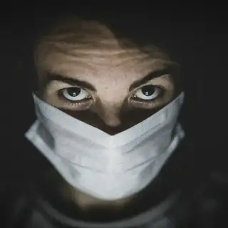 A man wearing a mask to protect from virus and bacteria in the air.
